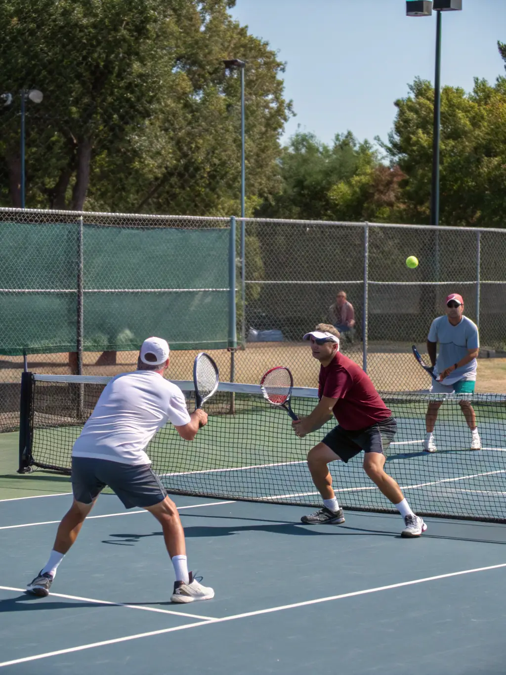 A dynamic shot of adults engaged in a competitive doubles match at TCR Tennis Club, showcasing the club's vibrant adult tennis community.